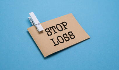 Stop Loss text appearing behind torn brown paper on blue background.