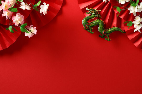 2024 Chinese New Year, year of the Dragon banner template with dragon, paper fans and flowers on red background