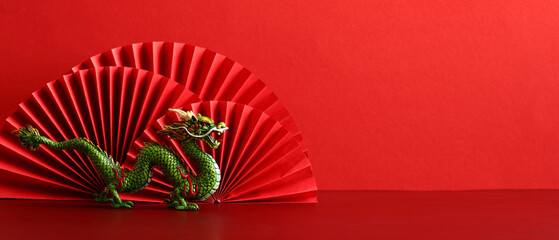 Chinese New Year 2024 banner template with dragon and paper cut fan decoration on red background.