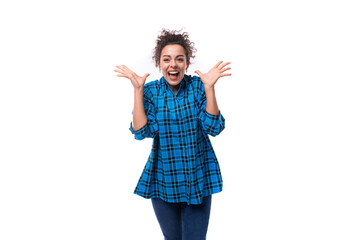 young woman with curly hair styling dressed in a blue shirt on a white background