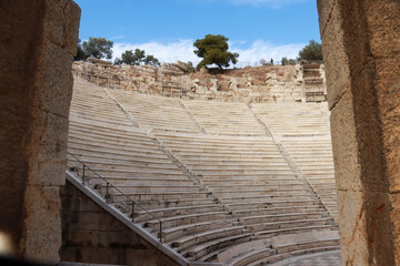 View of part of the Odeon of Herodes Atticus Theater foreground and the Parthenon in background