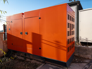 Orange coloured generator for the energy needs of the building.