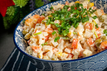 Traditional salad Olivier with boiled vegetables and mayonnaise.
