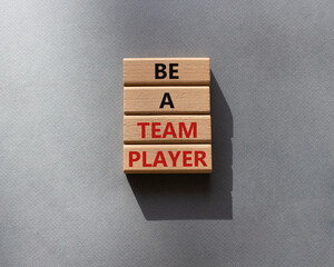 Be a team player symbol. Concept words Be a team player on wooden blocks. Beautiful grey background. Business and Be a team player concept. Copy space