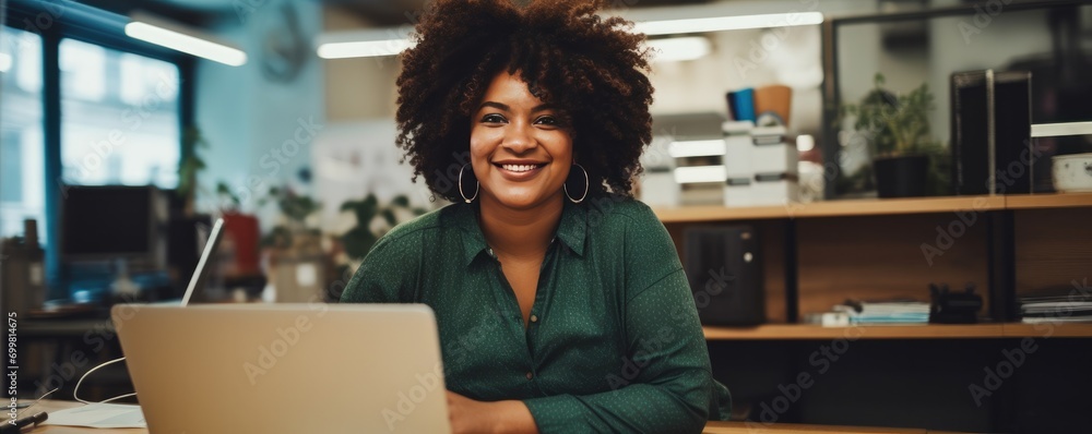 Wall mural portrait of smiling plus size woman near the laptop in the office. generative ai