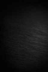 Black wood texture. Abstract dark background with wood texture pattern close-up. Soft focus