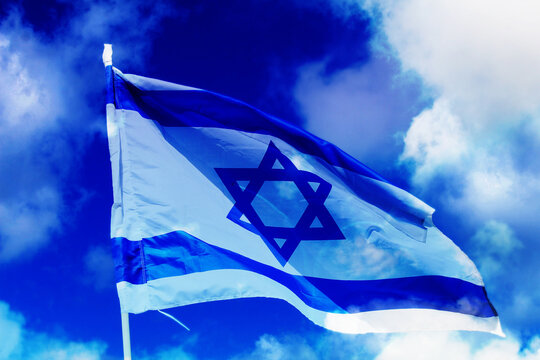 Israel. Flag of Israel against a background of blue sky with white clouds. Photo for Israel Independence Day
