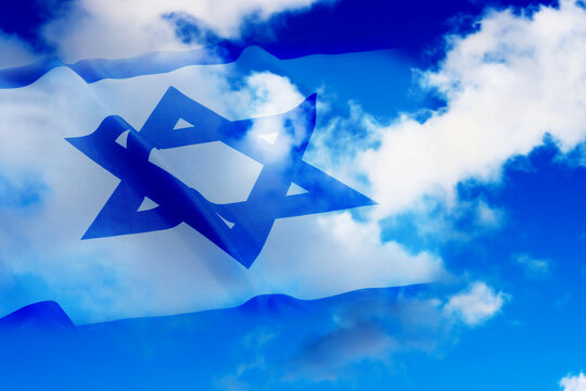 Israel. Israel Flag with Jewish star aganist the background of blue sky with white clouds. Photo for holiday Israel Independence Day