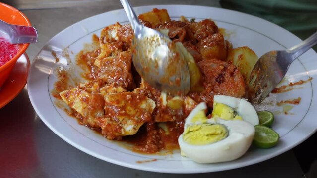 Siomay is a streetfood in Indonesia, contains of tofu, boiled egg, steamed potato, cabbage, and fish meatball, mixed with peanut sauce.