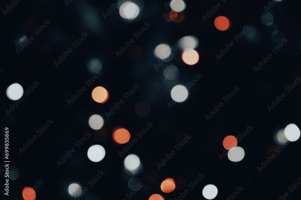Poster dark backdrop with a multicolored bokeh effect from scattered, out-of-focus light spots