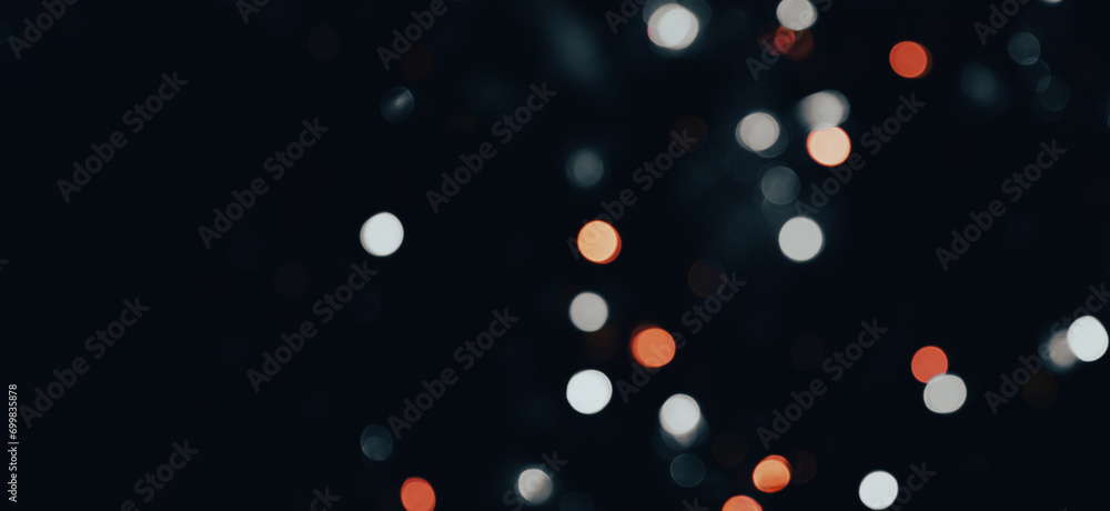 Poster dark backdrop with a multicolored bokeh effect from scattered, out-of-focus light spots