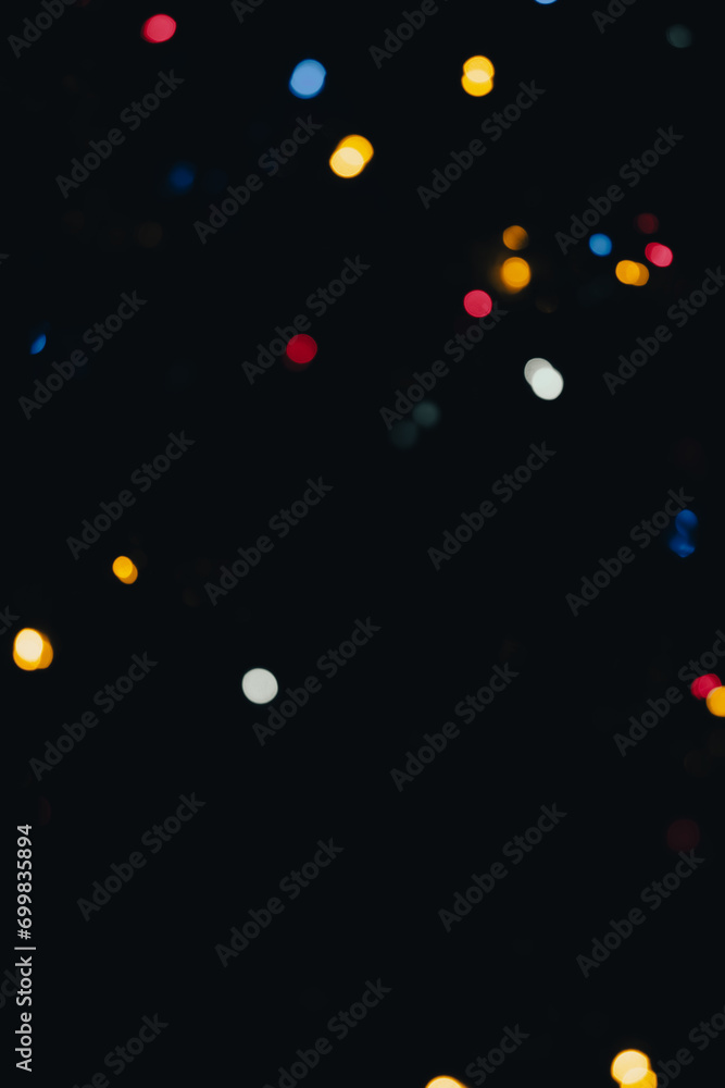 Poster vibrant display of multicolored bokeh lights against a dark background, creating a festive and magic