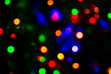festive and magical atmosphere with multicolored bokeh lights scattered against a dark background.