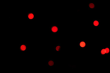 red glowing circles of varying sizes against a dark background, creating a mysterious and scattered...