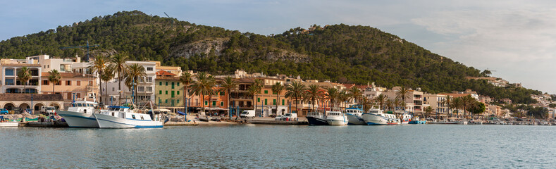 Fototapeta na wymiar Panoramic view of the dock with fishery ships in Andratx in the island of Majorca, Spain with mountains in background
