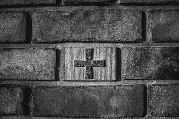 image of a Christian cross in a brick wall, religious procession, black and white photo