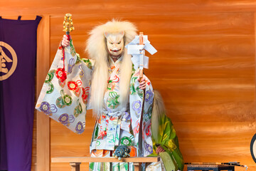 Kagura dance performed by the Inari fox deity holding suzu bells and a gohei wand which have the power to exorcise and purify evil spirits during the Konpira festival of Toranomon Kotohiragu shrine.
