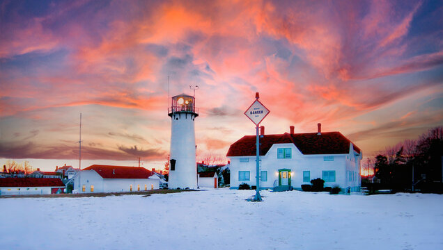 Chatham, Cape Cod Historic Lighthouse at Winter in Snow with Dramatic Sunsest