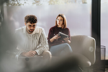 Young business professionals collaborate, strategize, and discuss project ideas in a creative office. Positive and successful teamwork.