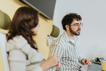 Businessman and female employee analyze statistics, discuss business growth, and make strategic decisions. Cozy workplace, innovative ideas, successful collaboration.