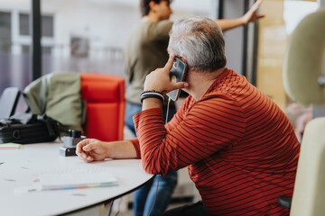 Amid urban vibes, the business owner negotiates a project, making key decisions over the phone.