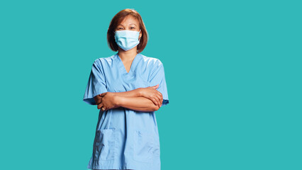 Upbeat smiling woman wearing protective clinical face mask to stop bacteria spreading. Portrait of...
