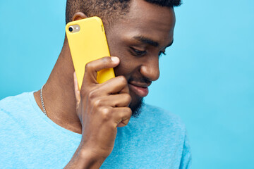 mobile man phone technology yellow smile young african typing black background happy - obrazy, fototapety, plakaty