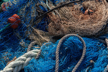 Industrial Fishing Equipment Fishnets and Fishing Lines lying on concrete in the port