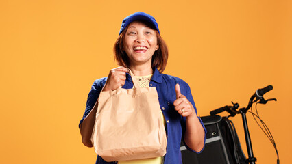 Slow motion portrait close up shot of impatient asian woman waiting for client to answer door,...