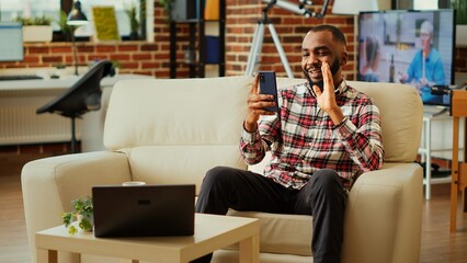Abroad living african american man remotely talking with his parents, making plans for future...