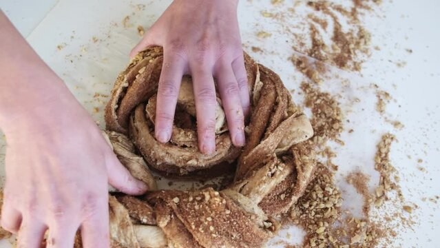 Preparing cruffin with nuts. Baking kraffin. Cook big cinnamon cruffin.