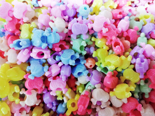 Fototapeta na wymiar Colorful skull shape plastic beads for sale in the accessories shop. Kid's DIY craft. Children's necklace beads.