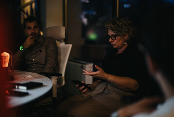 Group of colleagues discussing business growth strategies in an evening meeting at the office.