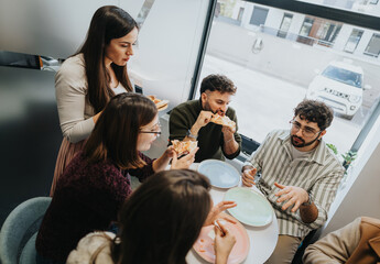 Fototapeta premium Diverse business team enjoying pizza break, fostering successful teamwork.