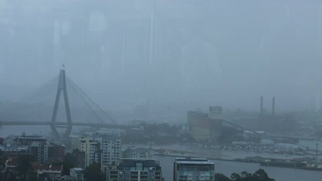Timelapse of a rainstorm passing over Sydney cityscape and bridge