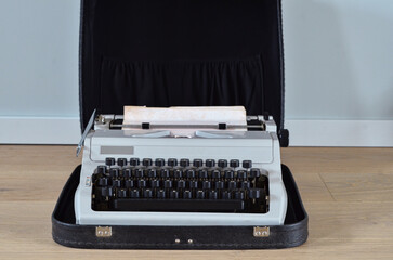 Vintage typewriter near light wall