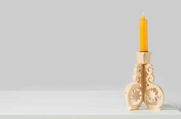 Vintage candle holder on table near light wall