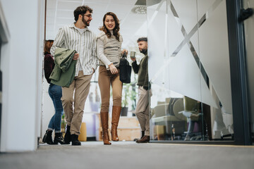Successful business people leaving work. Discussing and smiling.