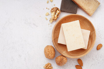 Composition with natural soap and nuts on light background