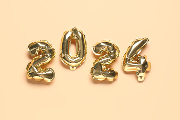 Figure 2024 made of balloons on orange background