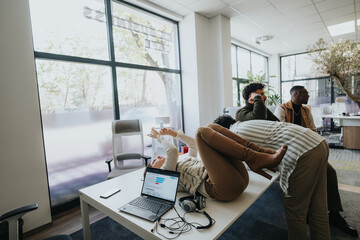 Diverse coworkers resting from work at the office, looking at something happening.