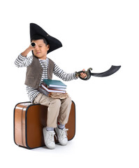 Cute little pirate with books, spyglass and toy sword on white background