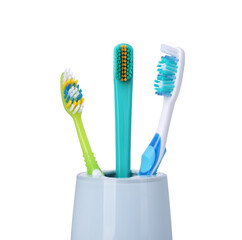 Different toothbrushes in holder isolated on white