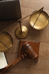 Law concept. Gavel and scales of justice on wooden table, flat lay