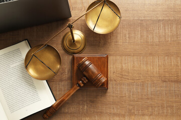Law concept. Gavel, book and scales of justice on wooden table, flat lay. Space for text