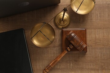 Law concept. Gavel, book and scales of justice on wooden table, flat lay