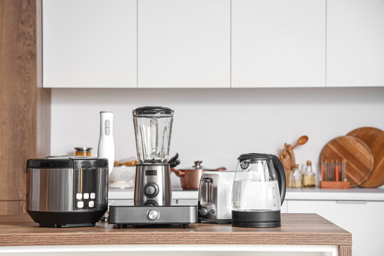 Set of appliances on wooden table in contemporary kitchen