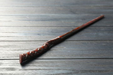 One old magic wand on grey wooden table