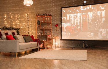 Interior of living room with Christmas lights, sofa and projector screen