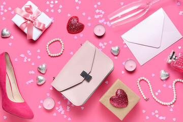 Woman accessories with envelope, gifts and decor on pink background. Valentine's Day celebration